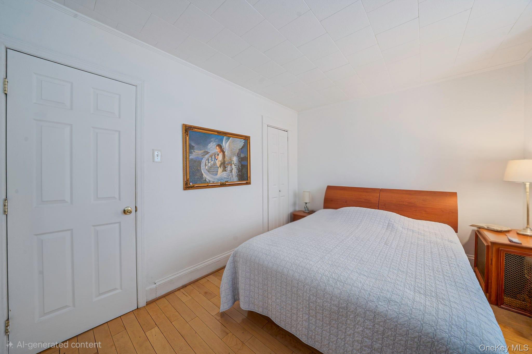 93-20 92nd Avenue Queens, NY 11421 - Photo 11 of 21 a bedroom with a bed and painting on the wall