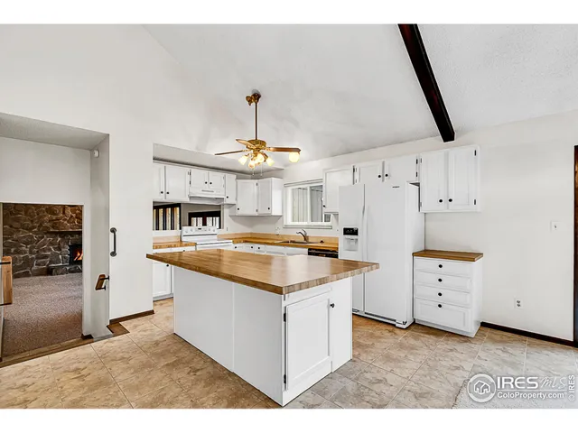 a kitchen with a stove a sink and a refrigerator