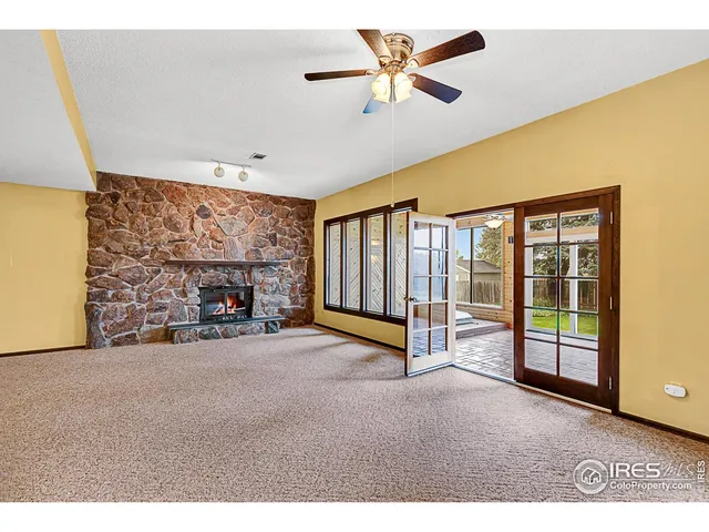 a living room with furniture a table and large window