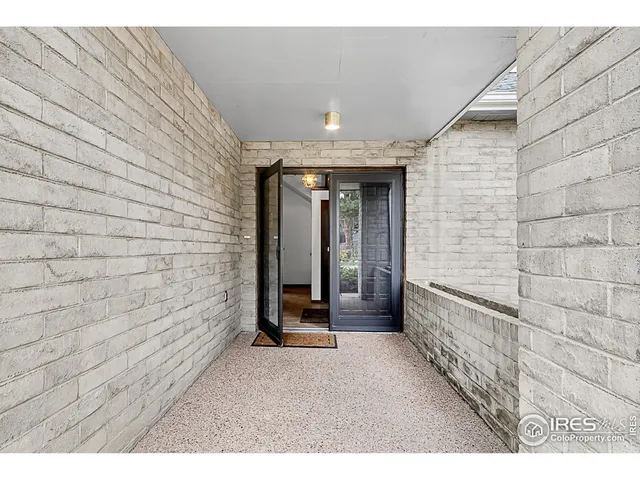 a view of a hallway with wooden shelves
