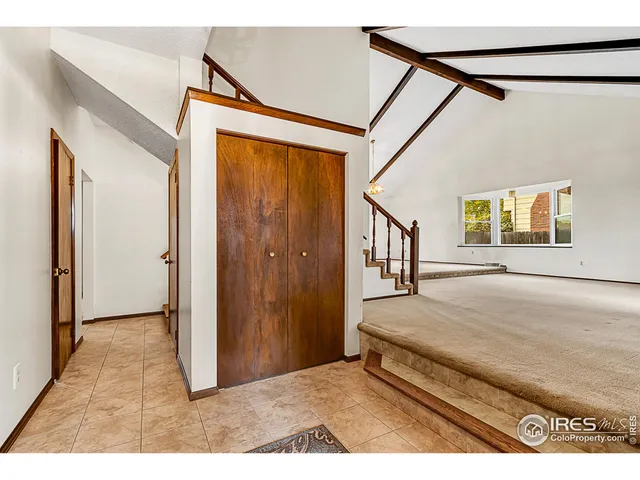 a view of a bedroom with wooden floor and windows