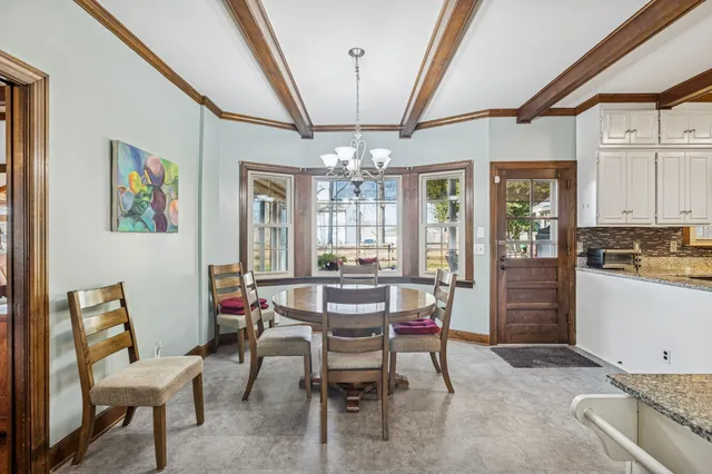 a view of a dining room with furniture and chandelier