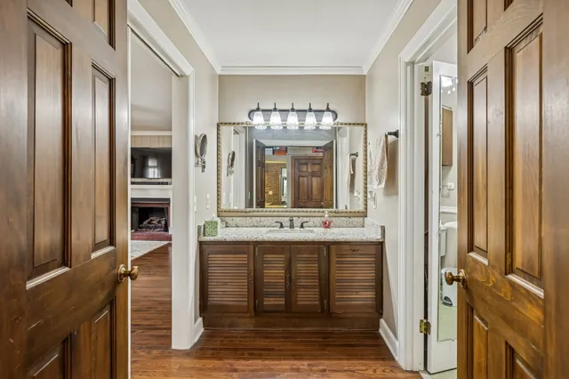 a bathroom with a granite countertop sink a mirror and a shower