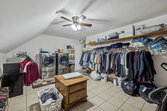 a view of walk in closet with clothes