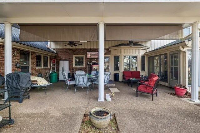 a view of a patio with dining table and chairs