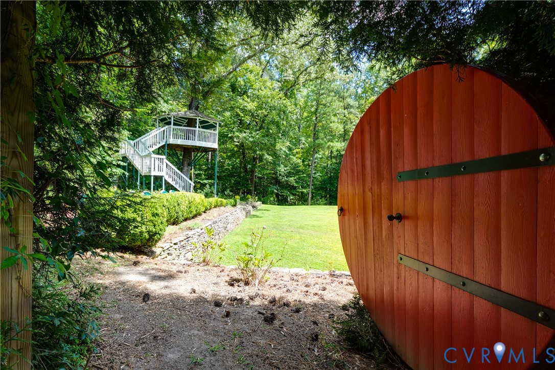 12778 Mt Hermon Road Ashland, VA 23005 - Photo 13 of 50 a view of a backyard with large trees and wooden fence