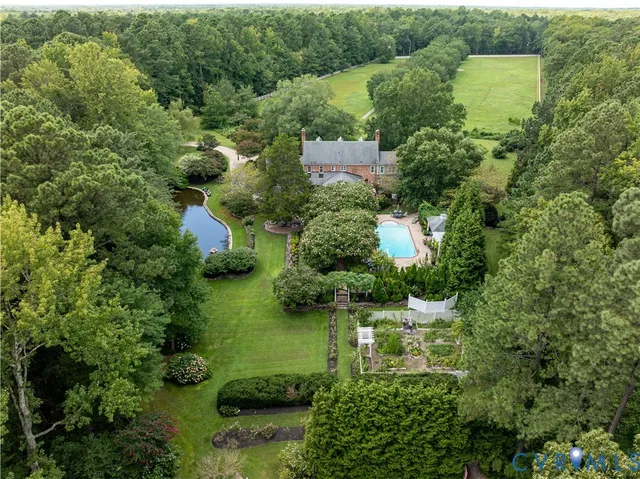 a view of empty room with wooden floor and fireplace
