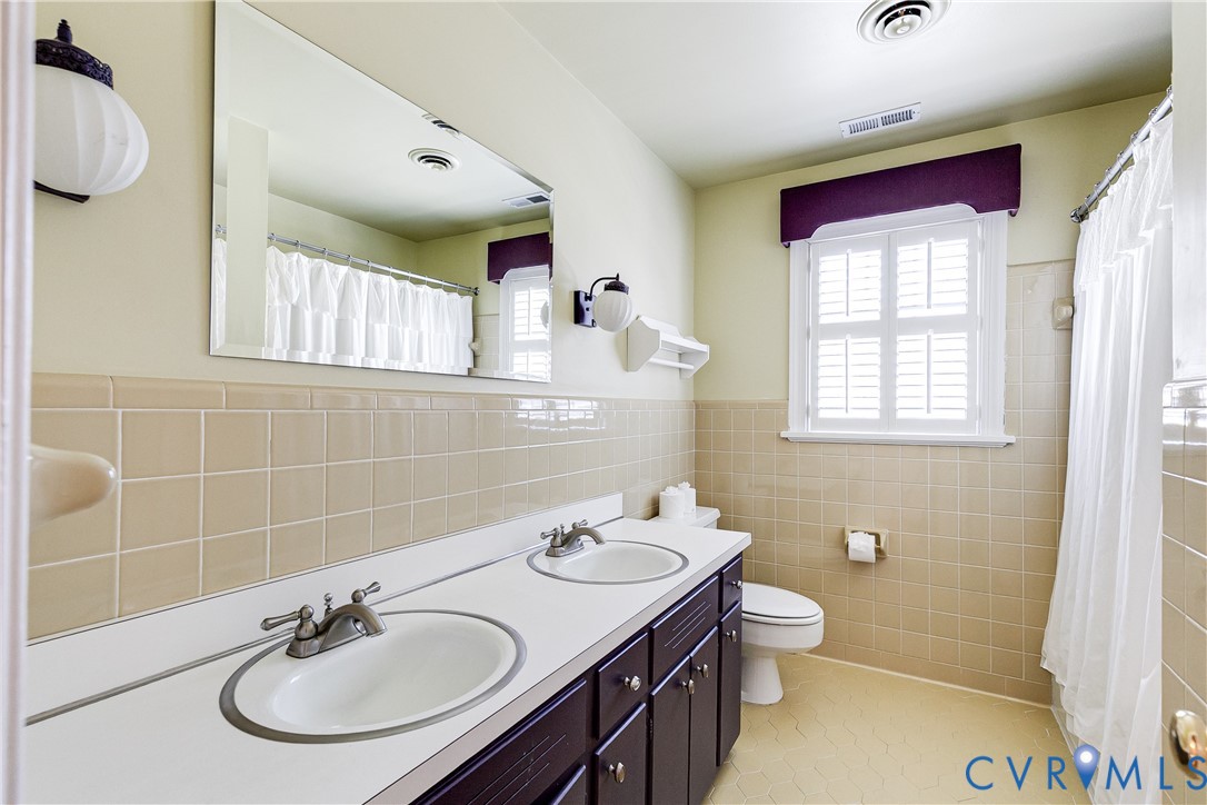 12778 Mt Hermon Road Ashland, VA 23005 - Photo 43 of 50 a bathroom with a sink a toilet and a mirror
