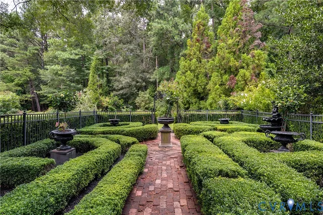 a view of a swimming pool with sitting area and garden