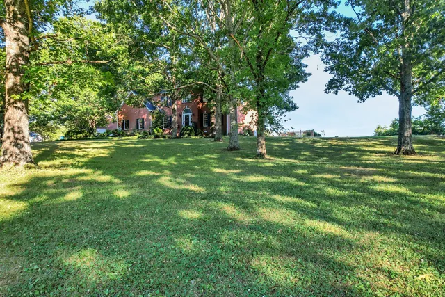 a kitchen with stainless steel appliances granite countertop table chairs sink and cabinets