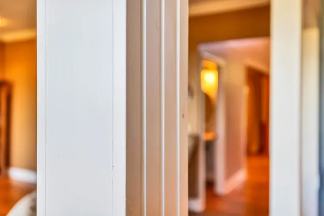 a bathroom with a granite countertop double vanity sink a mirror and a shower