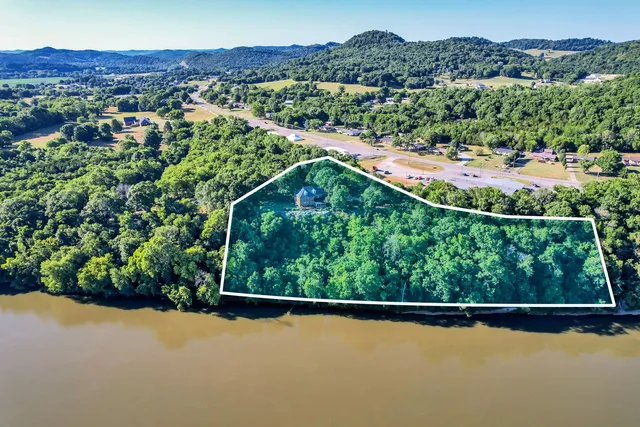 a dining room with furniture a chandelier and wooden floor