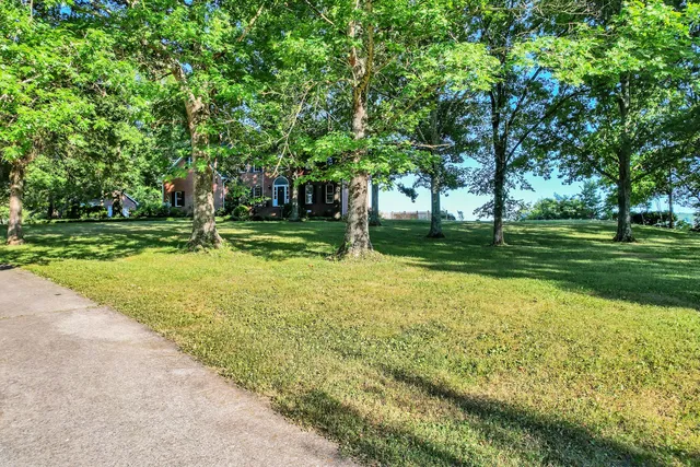 a large kitchen with stainless steel appliances granite countertop a sink and cabinets