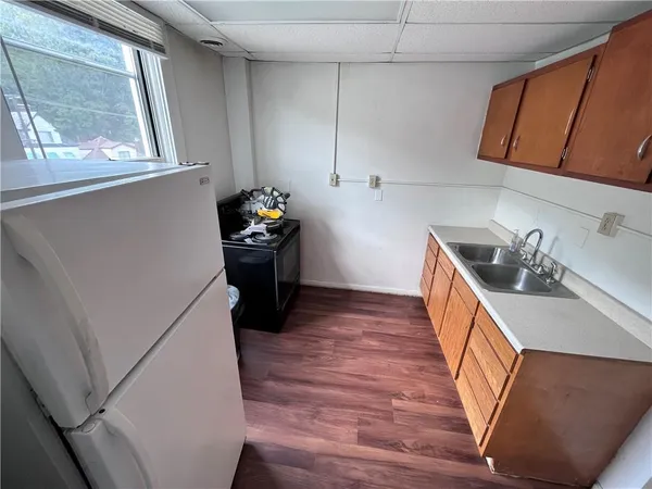 a kitchen with a wooden floor and a sink