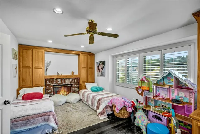 a bedroom with bed and large windows