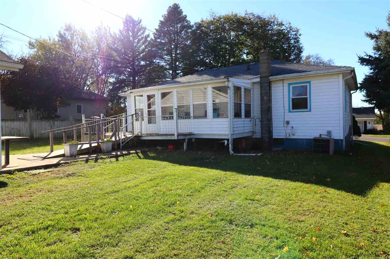 307 Jefferson Street Ridott, IL 61067 - Photo 13 of 16 a front view of a house with a yard table and chairs