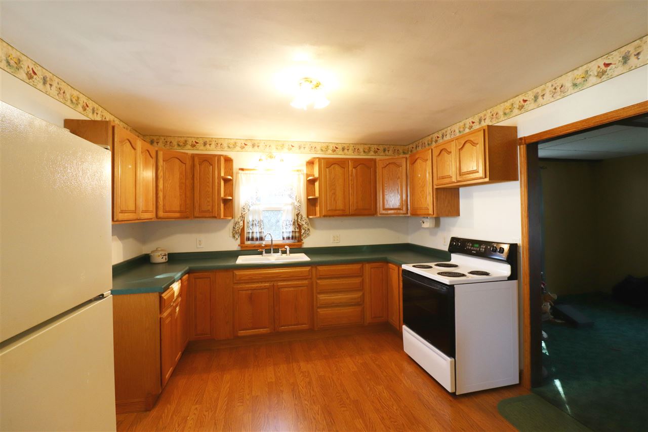 307 Jefferson Street Ridott, IL 61067 - Photo 2 of 16 a kitchen with stainless steel appliances granite countertop a stove a sink and a refrigerator