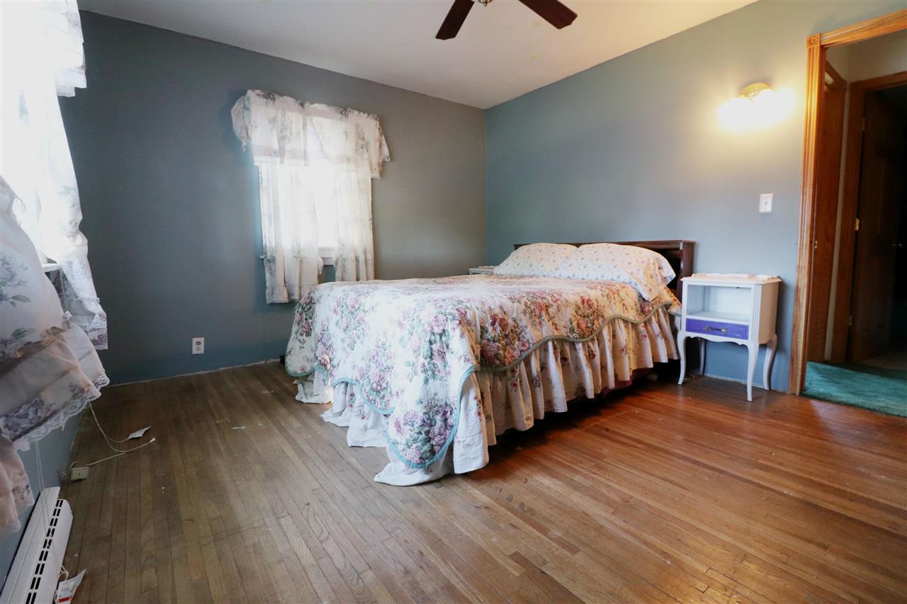 307 Jefferson Street Ridott, IL 61067 - Photo 4 of 16 a bedroom with a bed and a window