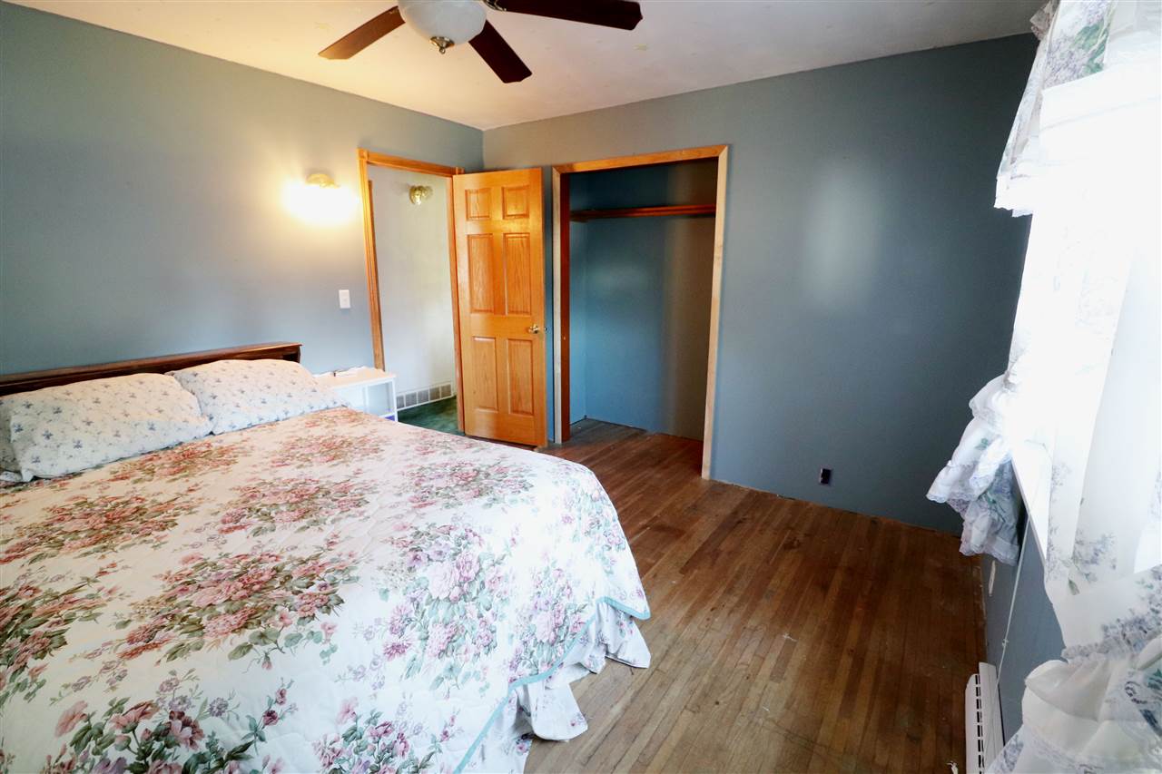 307 Jefferson Street Ridott, IL 61067 - Photo 5 of 16 a bedroom with a bed and a ceiling fan