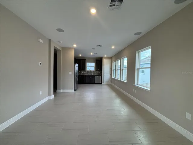 a view of empty room with a fireplace