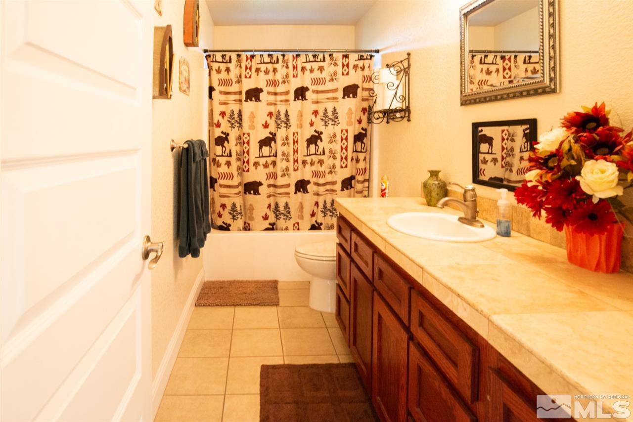 4767 Rancheria Road Fallon, NV 89406 - Photo 12 of 25 a bathroom with a sink and a mirror