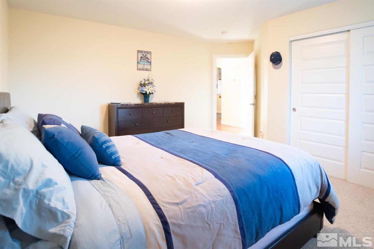 4767 Rancheria Road Fallon, NV 89406 - Photo 14 of 25 a bedroom with a bed and a mirror