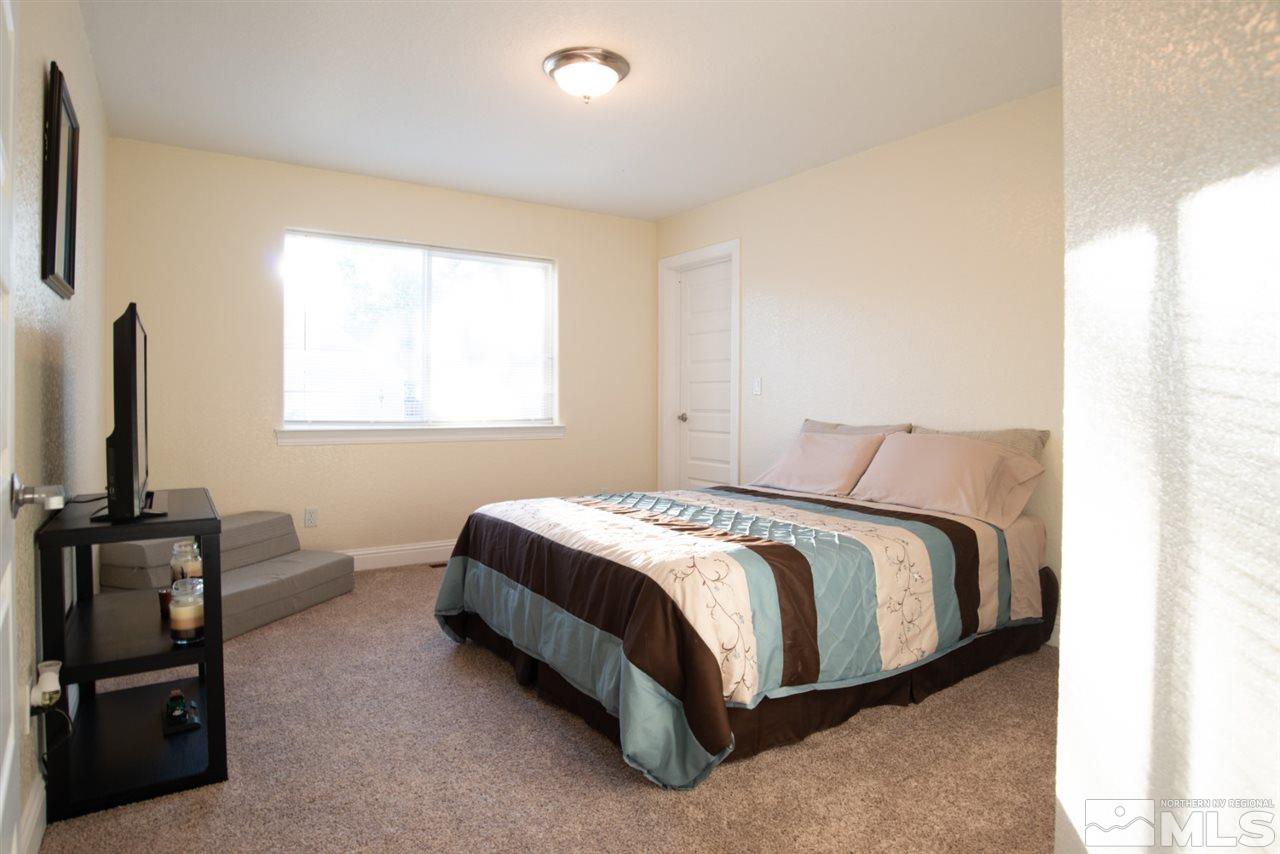 4767 Rancheria Road Fallon, NV 89406 - Photo 15 of 25 a bedroom with a bed and flat tv screen