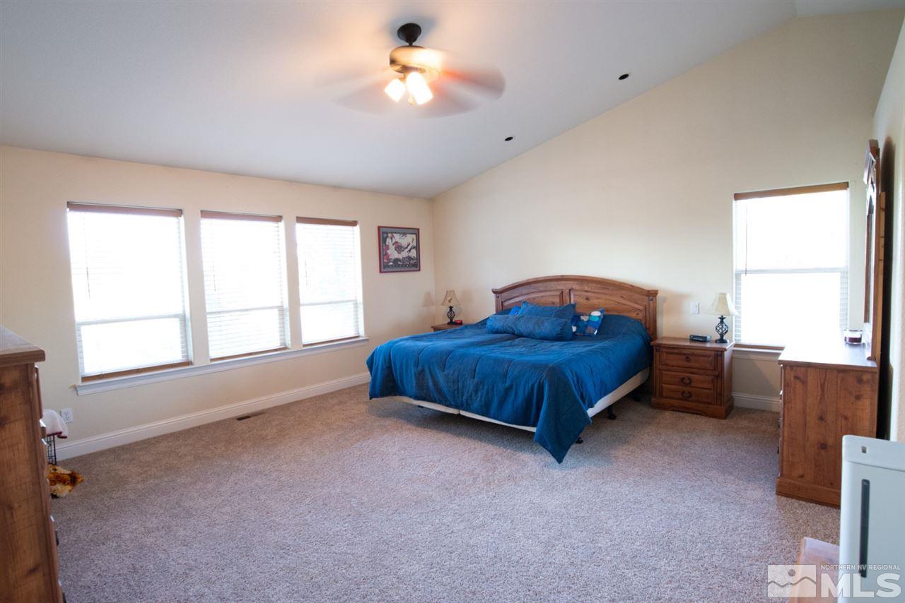 4767 Rancheria Road Fallon, NV 89406 - Photo 18 of 25 a spacious bedroom with a bed and a window