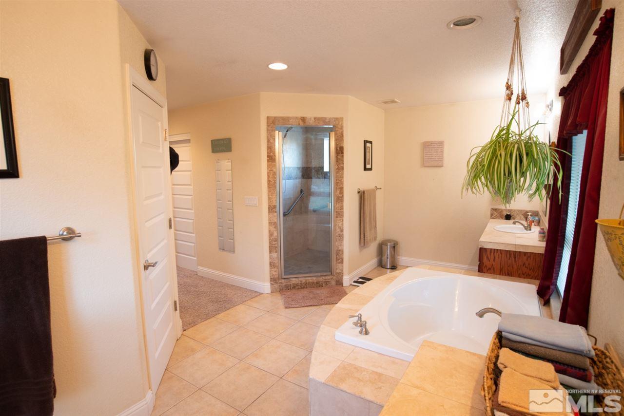 4767 Rancheria Road Fallon, NV 89406 - Photo 20 of 25 a bathroom with a tub shower and sink