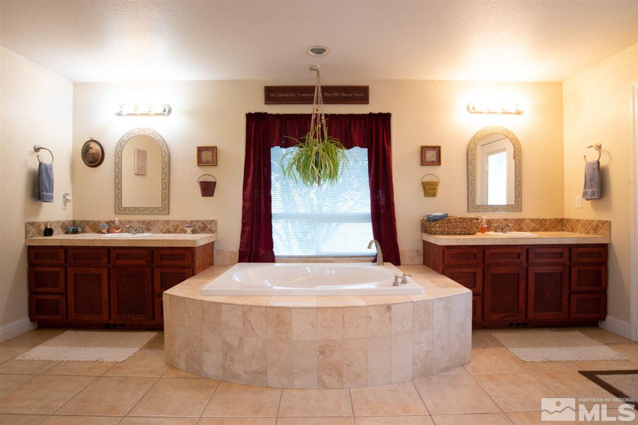 4767 Rancheria Road Fallon, NV 89406 - Photo 21 of 25 a spacious bathroom with a tub sink and mirror