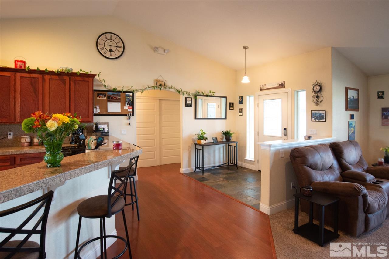4767 Rancheria Road Fallon, NV 89406 - Photo 6 of 25 a living room with furniture a chandelier and a dining table