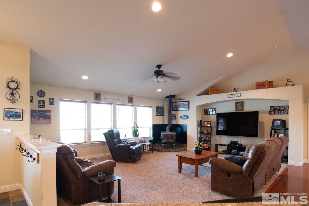 4767 Rancheria Road Fallon, NV 89406 - Photo 7 of 25 a living room with furniture a flat screen tv and a fireplace