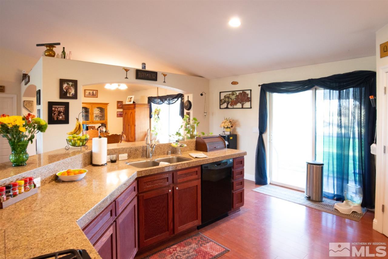 4767 Rancheria Road Fallon, NV 89406 - Photo 9 of 25 a spacious bathroom with a granite countertop sink and a mirror