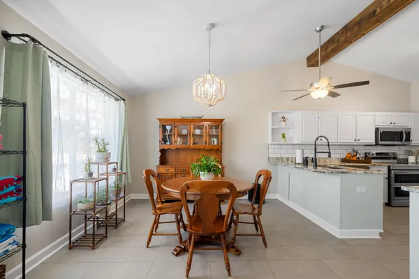 a dining room with furniture and window
