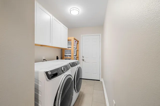 a view of washer and dryer with kitchen in the background