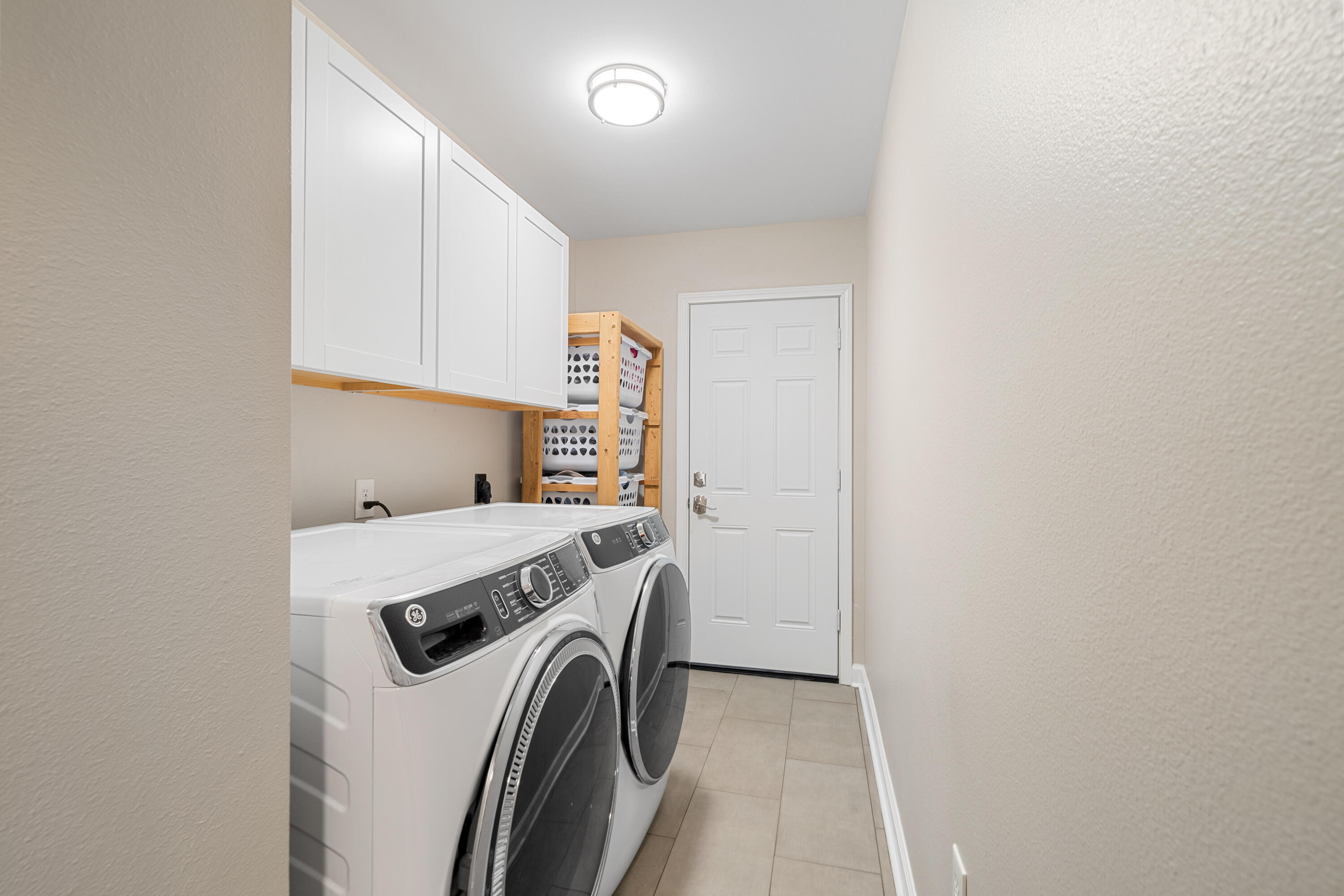 1933 Eagle Lane Navarre, FL 32566 - Photo 17 of 40 a view of washer and dryer with kitchen in the background