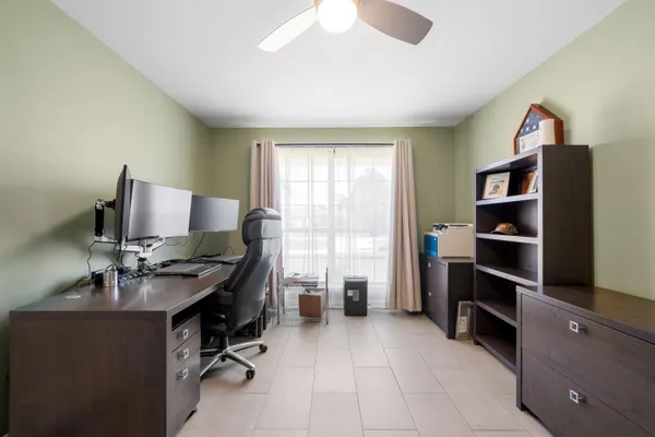 a view of a workspace with furniture and a window