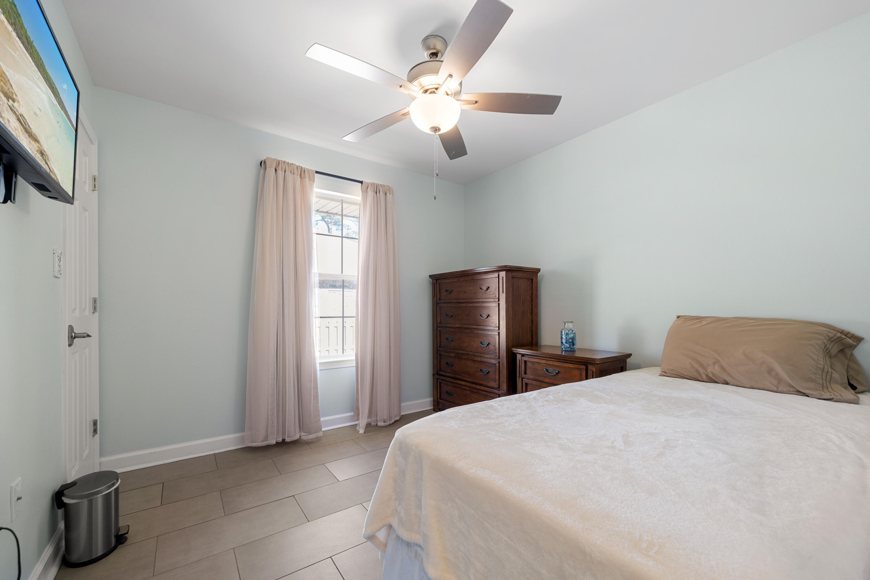 1933 Eagle Lane Navarre, FL 32566 - Photo 20 of 40 a bedroom with a bed and a chandelier