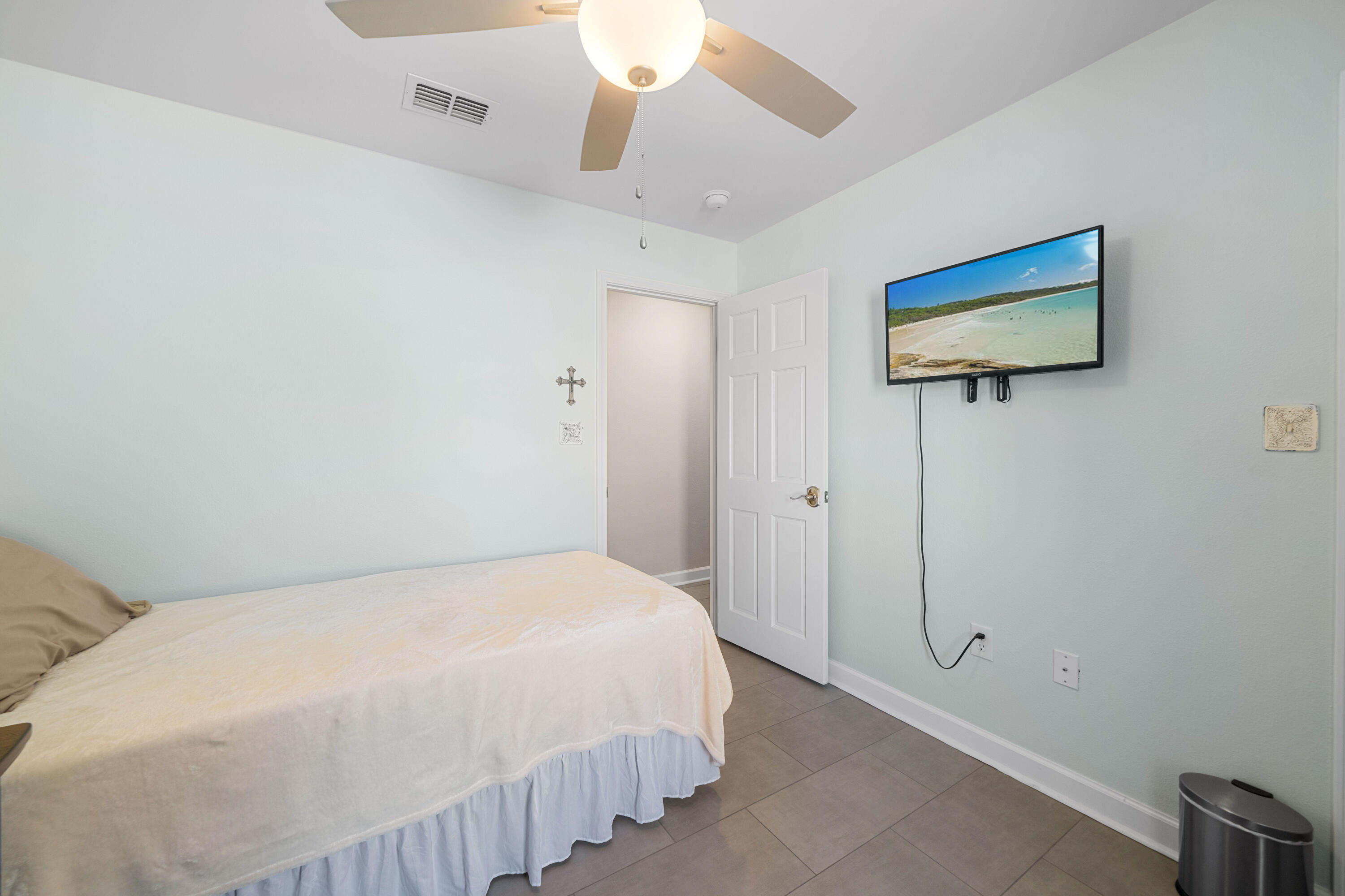1933 Eagle Lane Navarre, FL 32566 - Photo 21 of 40 a bedroom with a bed and a ceiling fan