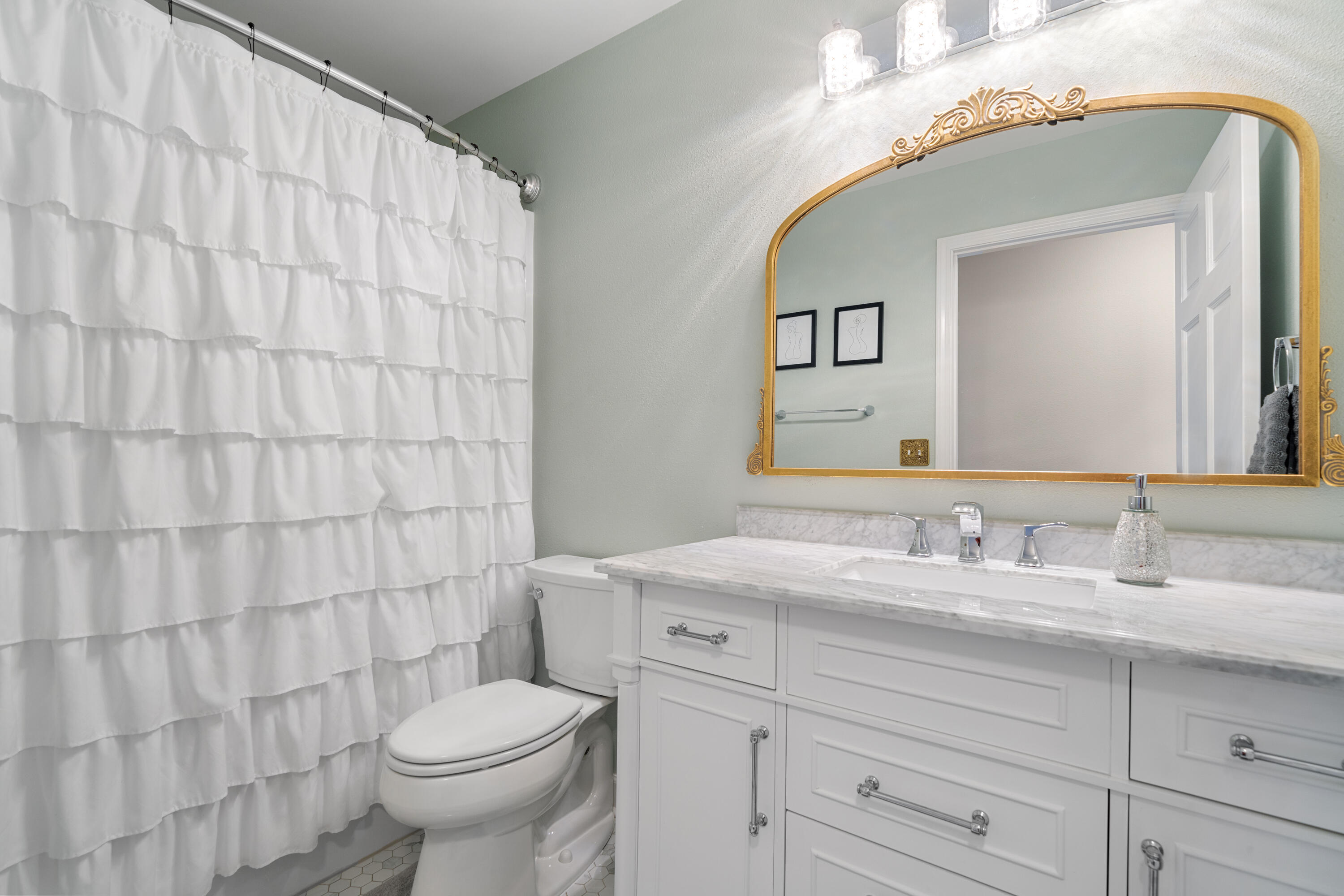 1933 Eagle Lane Navarre, FL 32566 - Photo 22 of 40 a bathroom with a sink a toilet and mirror