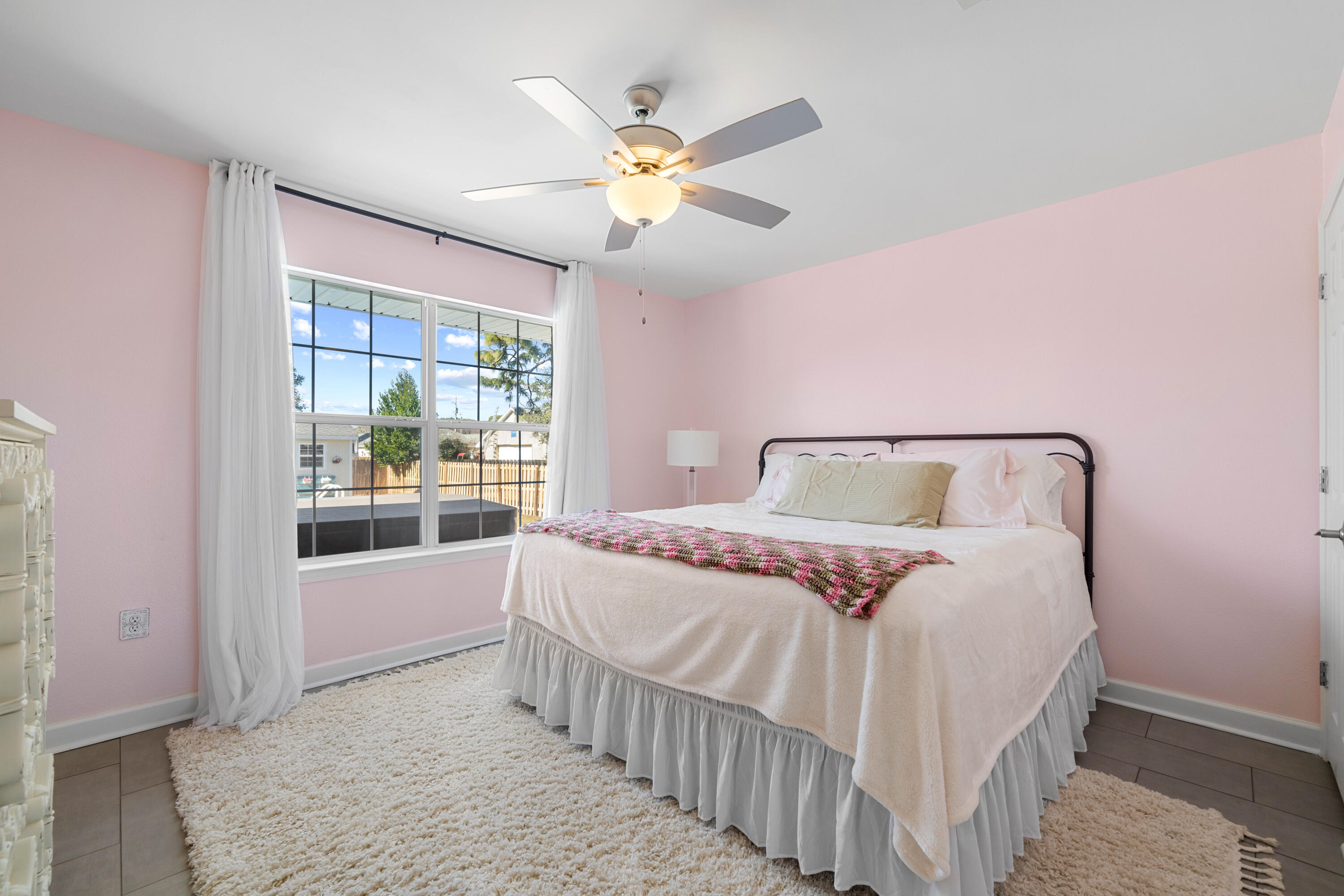 1933 Eagle Lane Navarre, FL 32566 - Photo 24 of 40 a bedroom with a bed and window