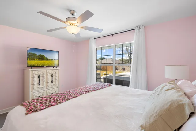 a bedroom with a bed and ceiling fan