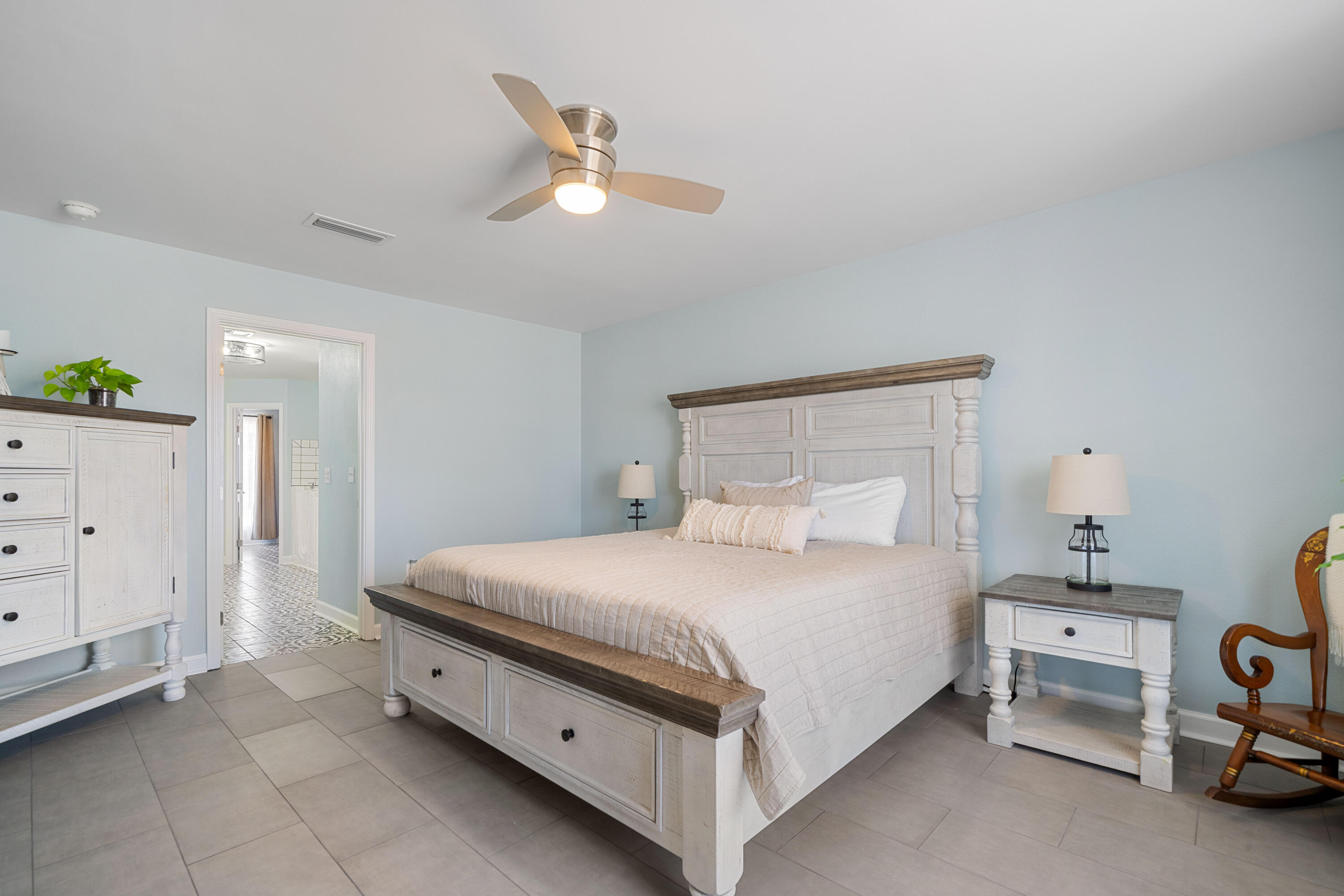 1933 Eagle Lane Navarre, FL 32566 - Photo 26 of 40 a bedroom with a bed and a chandelier