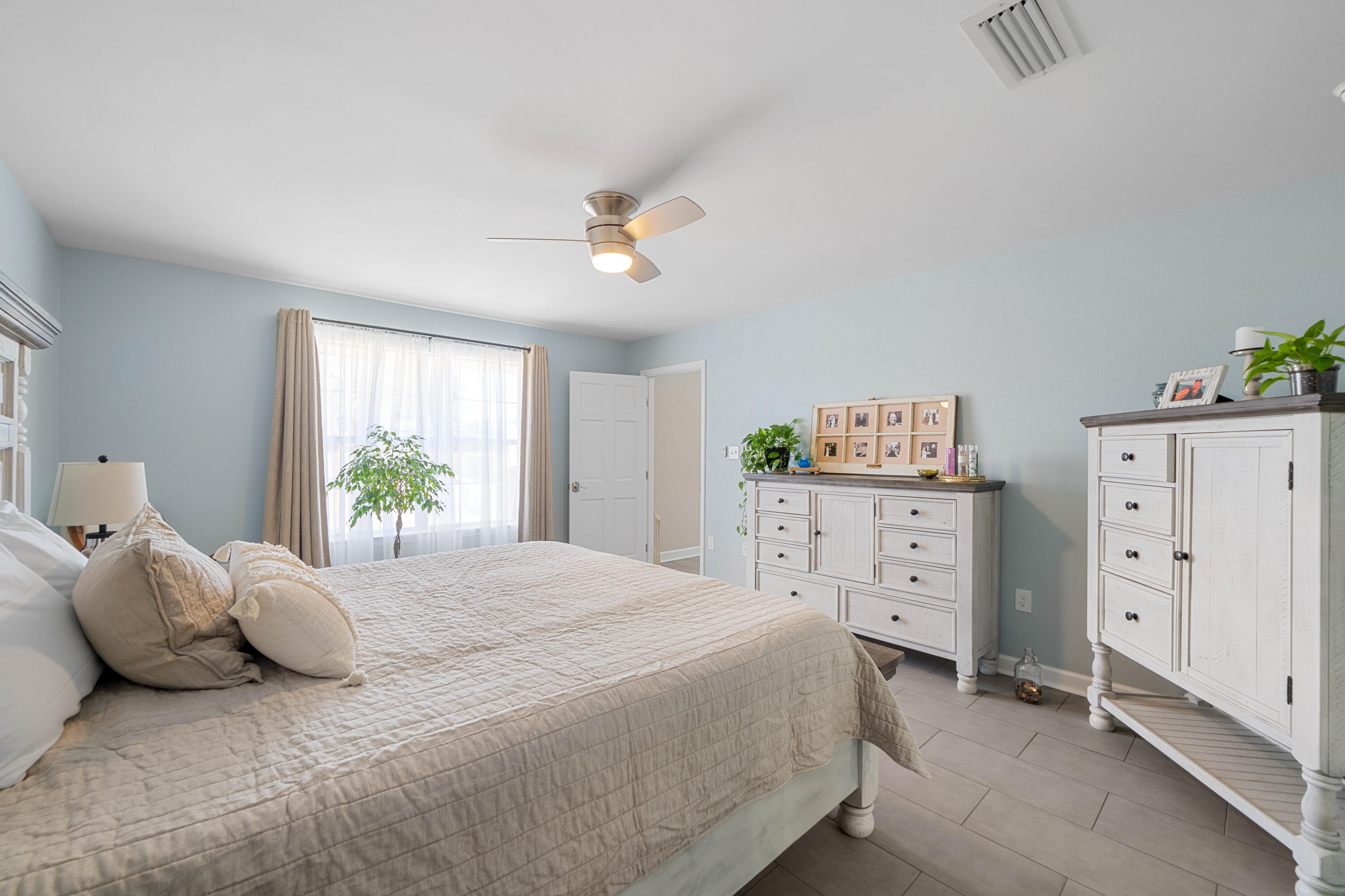 1933 Eagle Lane Navarre, FL 32566 - Photo 28 of 40 a bedroom with a bed dresser and a window