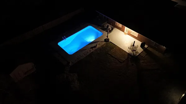 a blue bed sitting in a room next to a window
