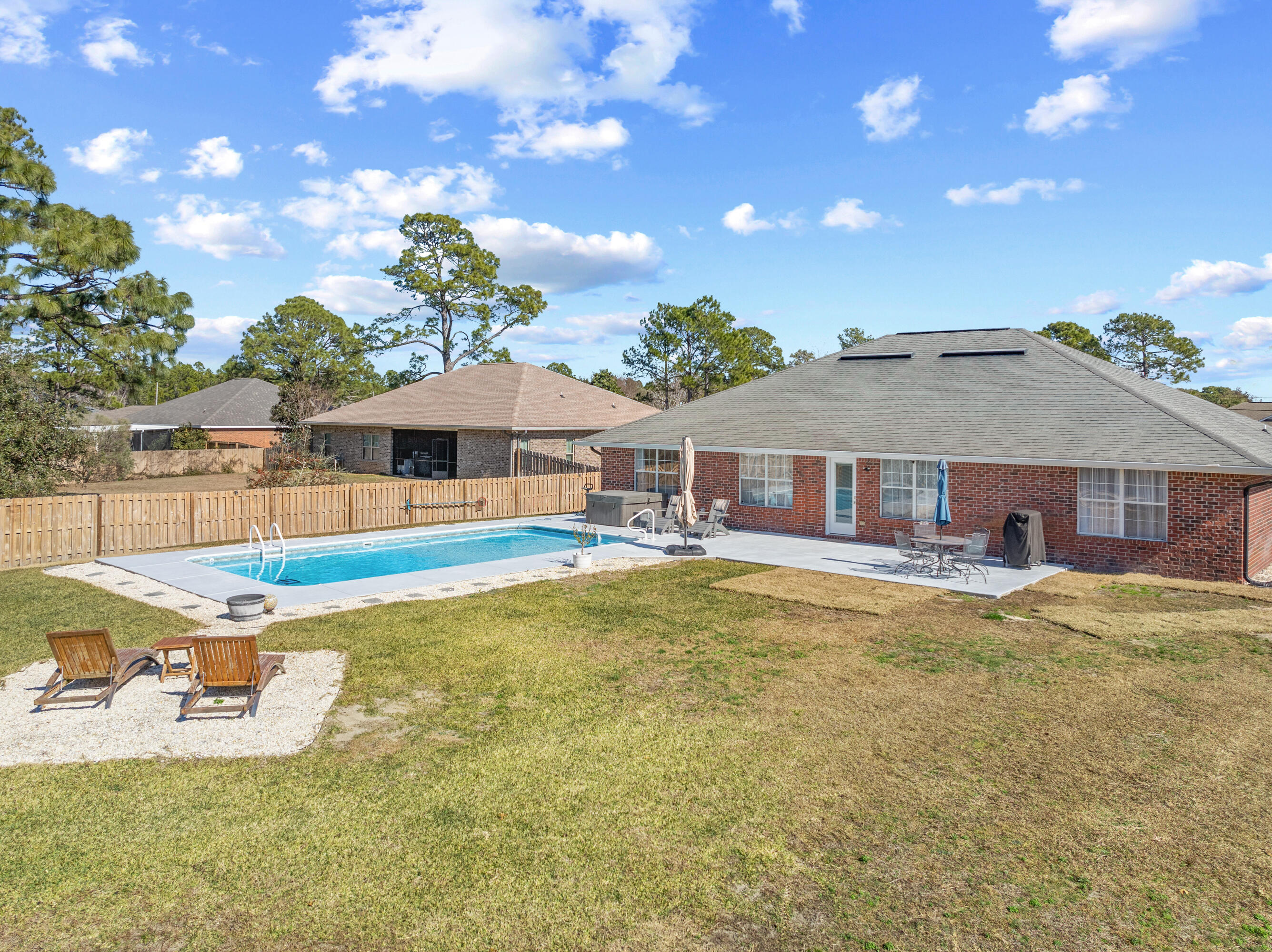 1933 Eagle Lane Navarre, FL 32566 - Photo 6 of 40 a view of a house with pool and chairs