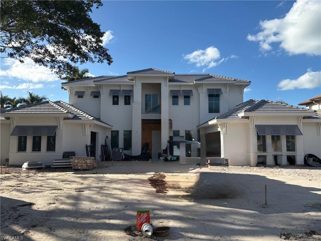 1985 Crayton Road Naples, FL 34102 - Photo 2 of 8 a view of a house with a large windows