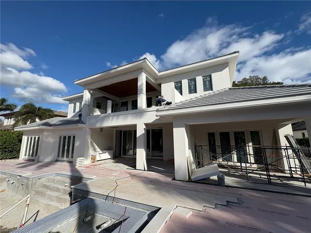 a view of house with car parked in front of it