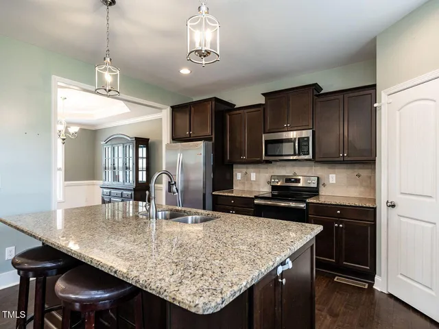 a kitchen with kitchen island granite countertop a sink and center island