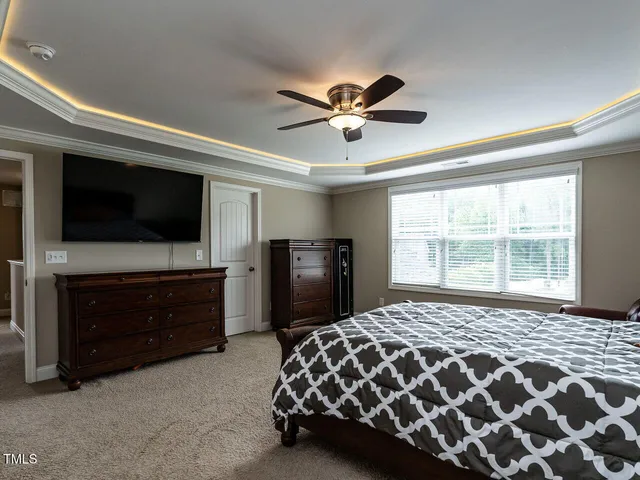 a bedroom with a bed and a television